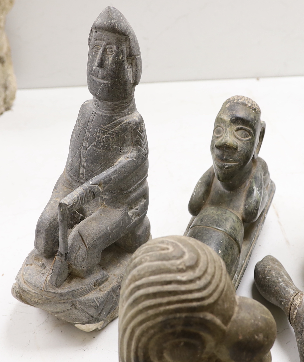 Eight Shona stone carvings, 1960s-70s including a kneeling figure and sleeping figure,both signed D.S. Dube, other figures, heads and abstract sculpture forms, tallest 35cm